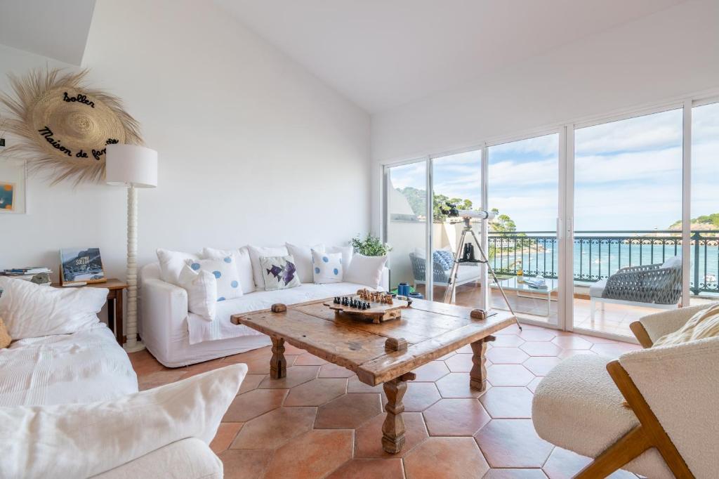 a living room with a couch and a table at Beachfront Apartment Port de Soller in Sóller
