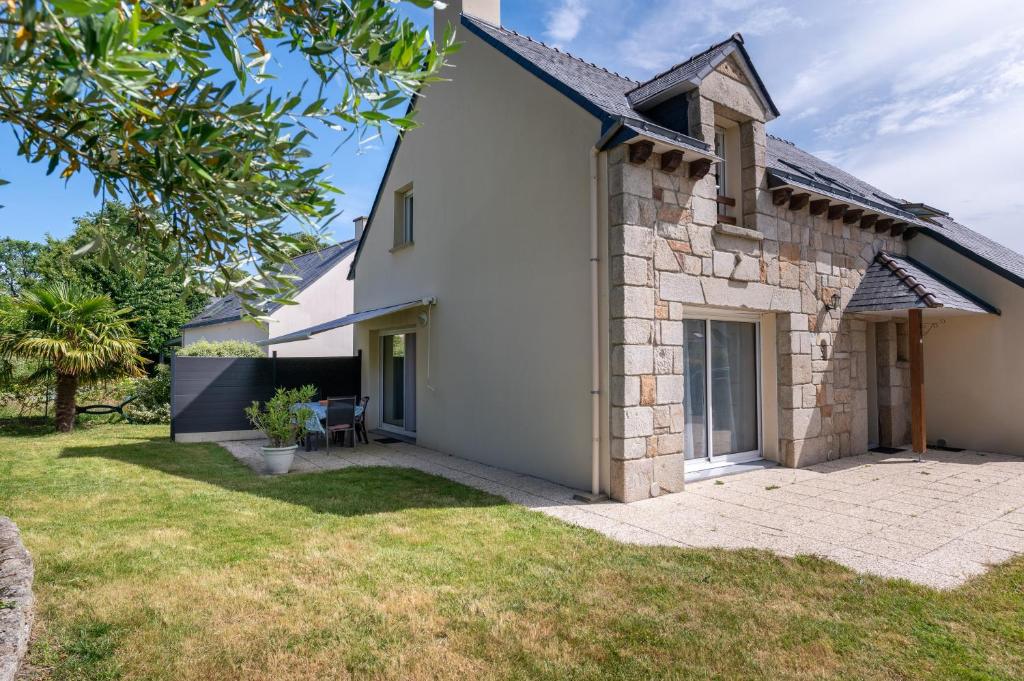 an exterior view of a white house with a yard at Ty Gwen in Ploeren
