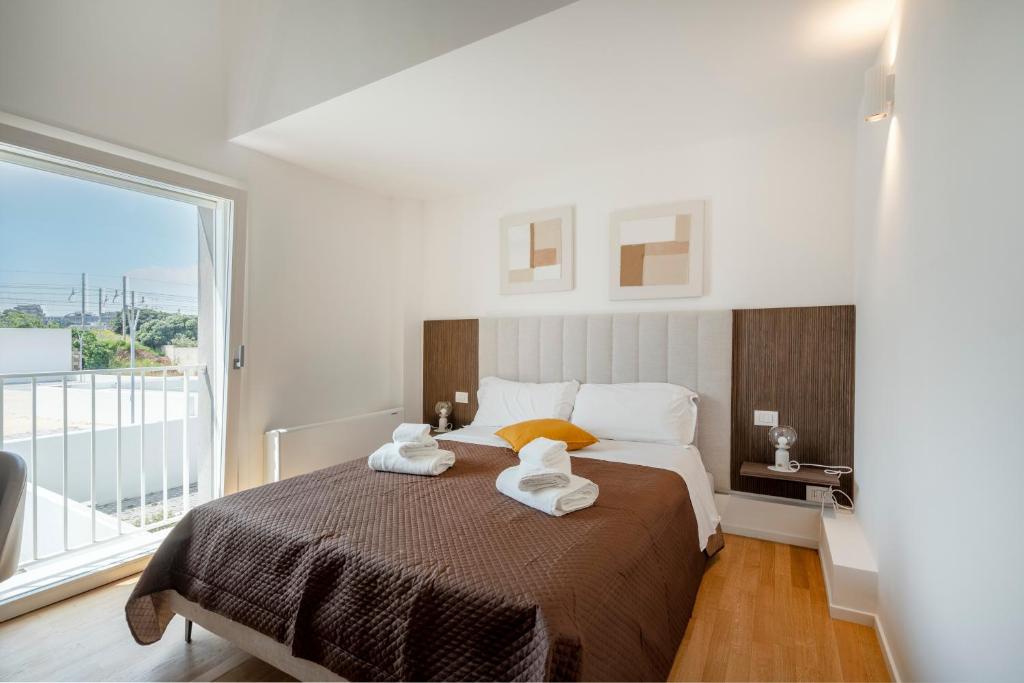a bedroom with a large bed with towels on it at Luxury Home in Bari
