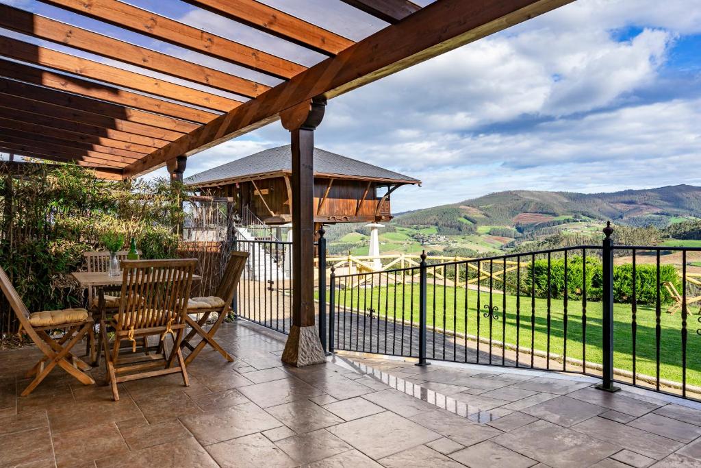 a patio with a gazebo and a table and chairs at R de Alborada del eo in Villameitide