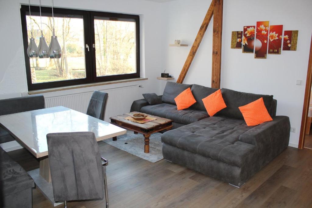 a living room with a couch and a table at Ferienwohnung Am Wehr in Georgensgmünd
