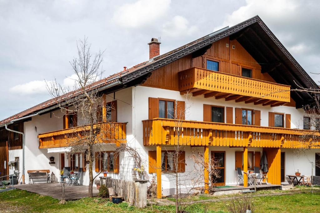 a large wooden house with a balcony at Beim Blitz ehemals Haus Maier in Schwangau