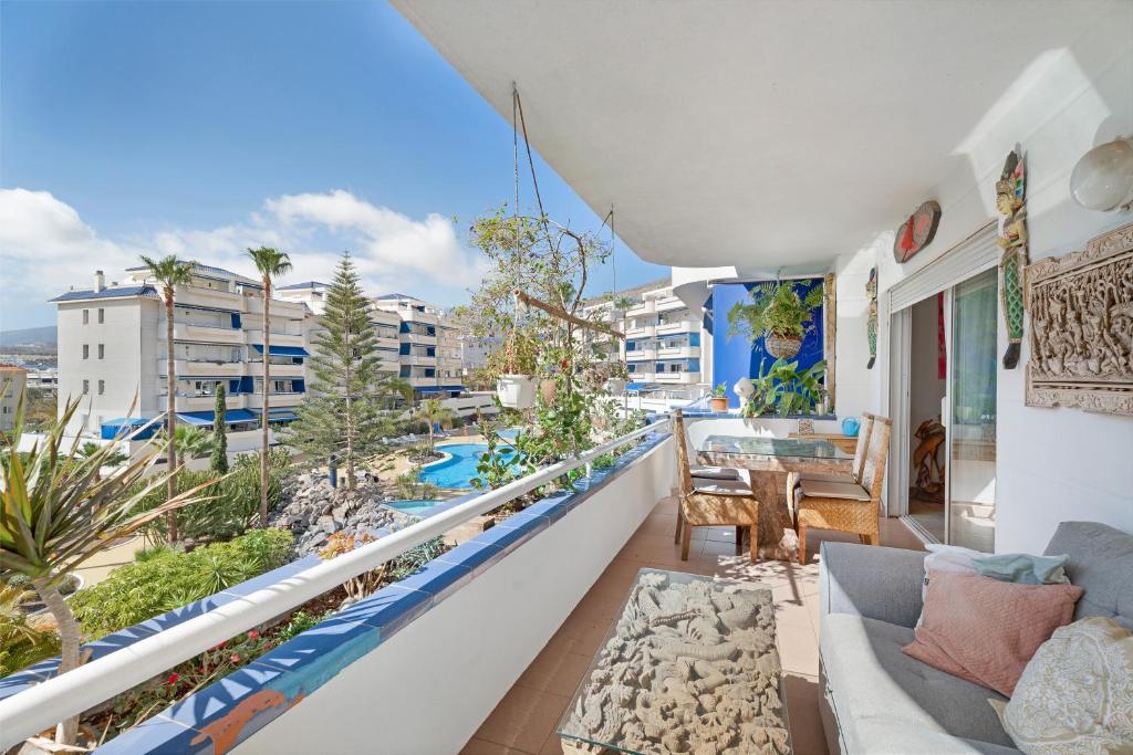 a balcony with a couch and a view of a city at Playa Graciosa in Arona