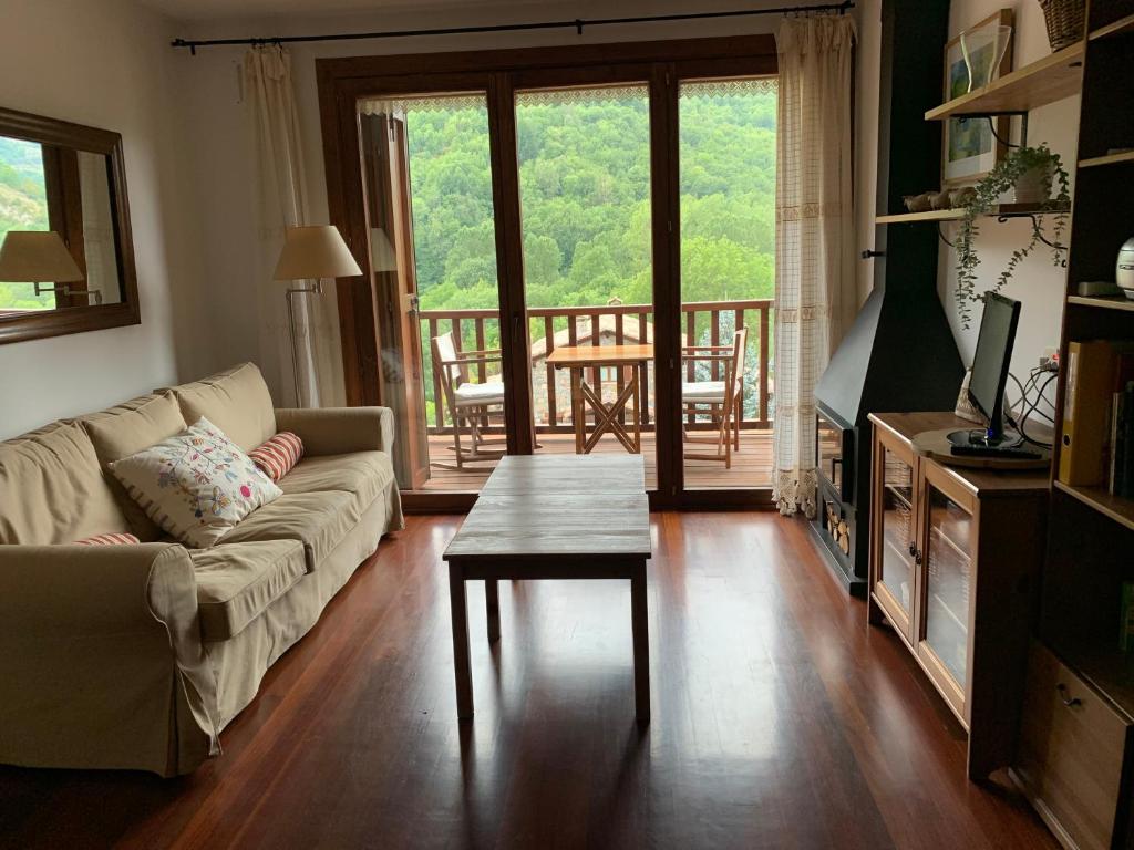 a living room with a couch and a table at El Mirador de Llanars in Llanars