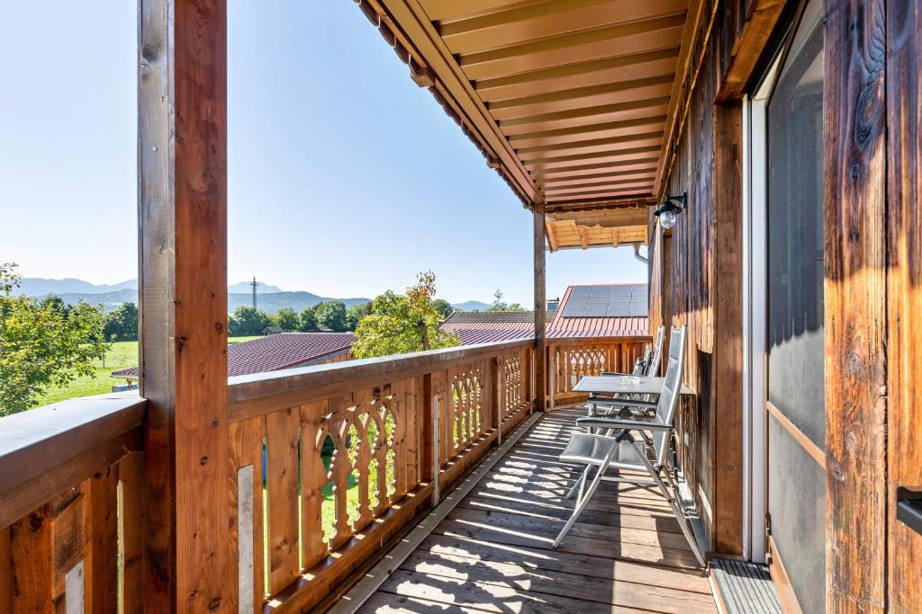 a deck with chairs on the side of a house at Wohnung Untersbergblick in Freilassing