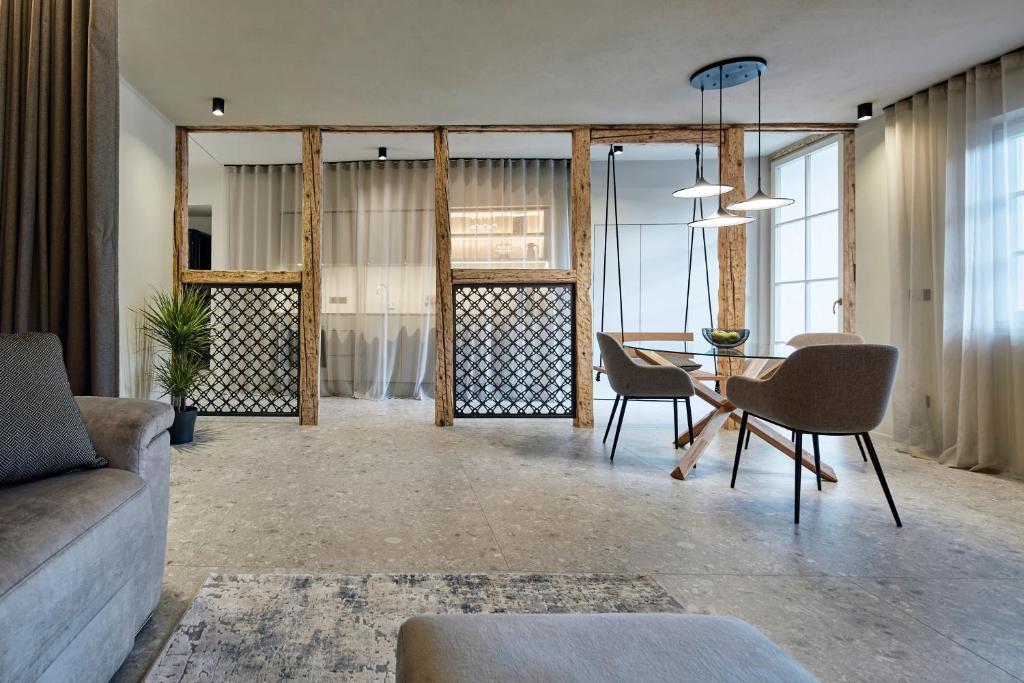a living room with a couch and a table and chairs at Truma Swing Luxury in Merano