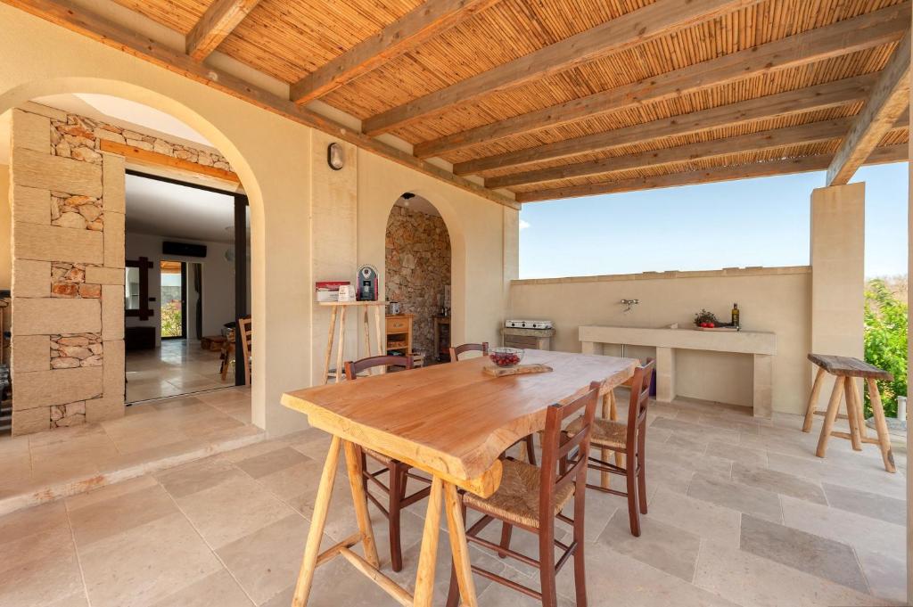 a kitchen and dining room with a wooden table and chairs at La casa di Rollo in Otranto