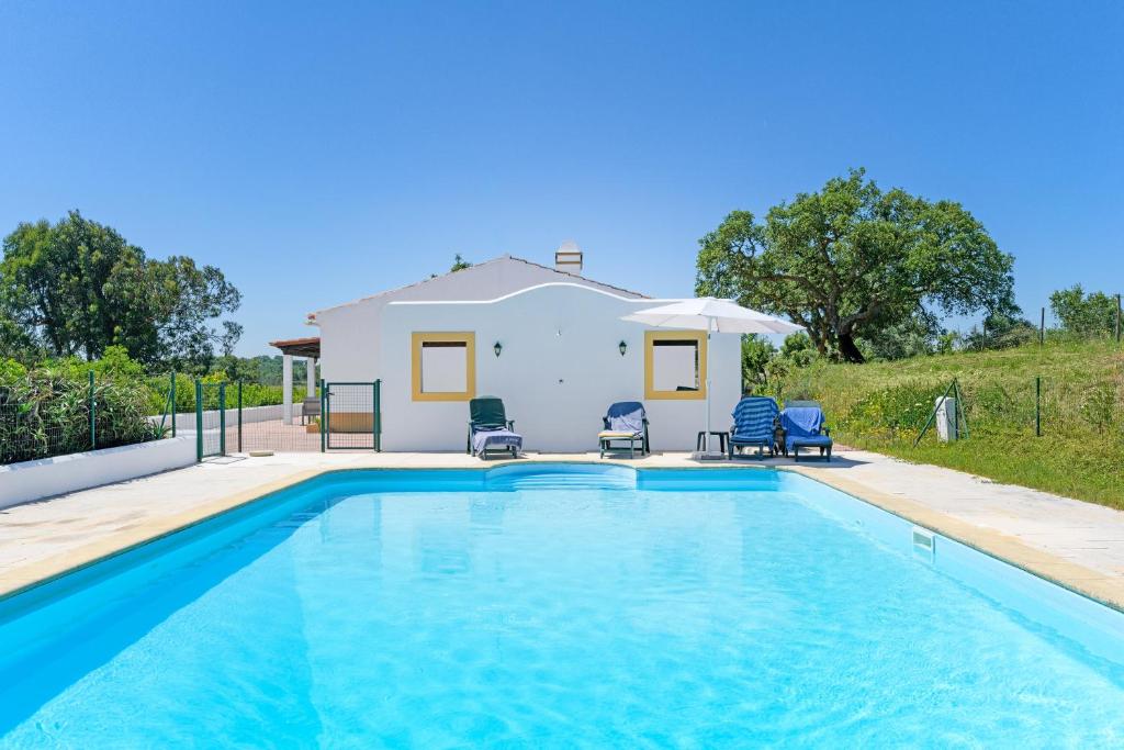 a swimming pool in front of a house at Monte do Cerro Verde in Santiago do Cacém