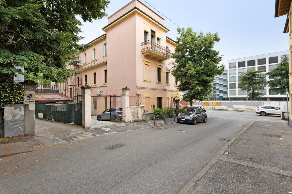 a car parked in front of a pink building at Affittacamere Borgo Trento in Verona