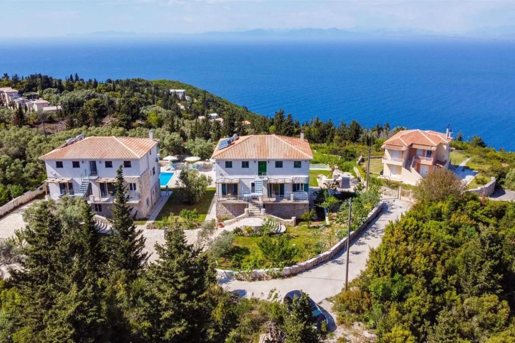 an aerial view of a house with the ocean in the background at Groundfloor Studio 1 in Tsoukalades