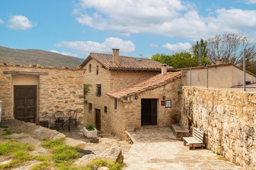 an old stone house with a patio in front of it at Moli d' en Pi in Morella