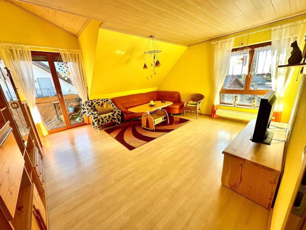 a living room with a couch and a table at Ferienwohnung Huber in Oppenau