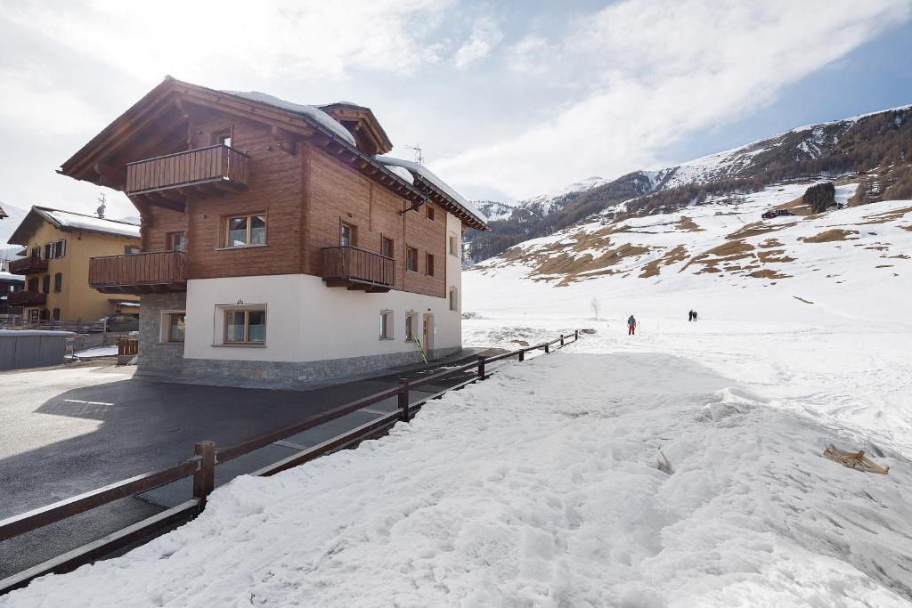 a building on top of a snow covered mountain at Alpi Flo Chalet in Livigno