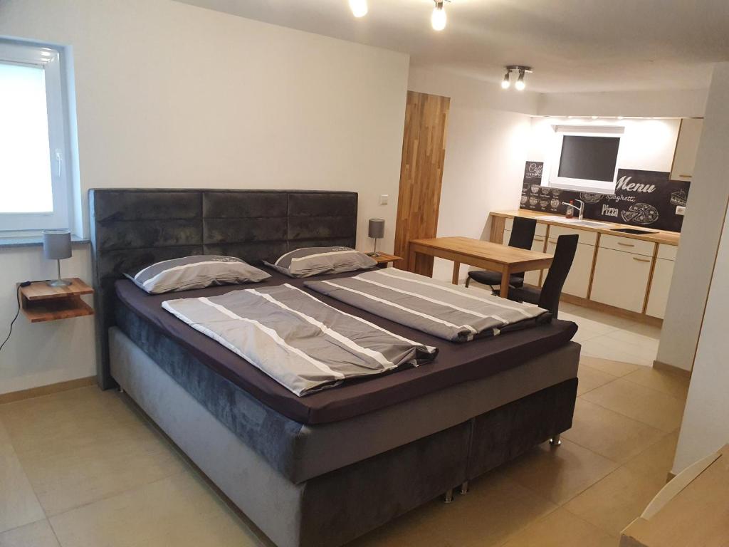 a bedroom with a large bed in a room at Casa Rindler in Sigmarszell