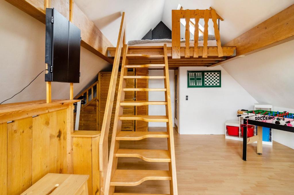 a room with wooden stairs and a bunk bed at Haus am Rand des Harz in Bad Lauterberg
