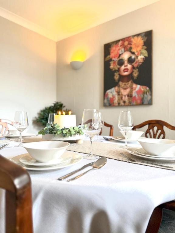 a dining room table with a white table cloth on it at Joshua House in Newquay