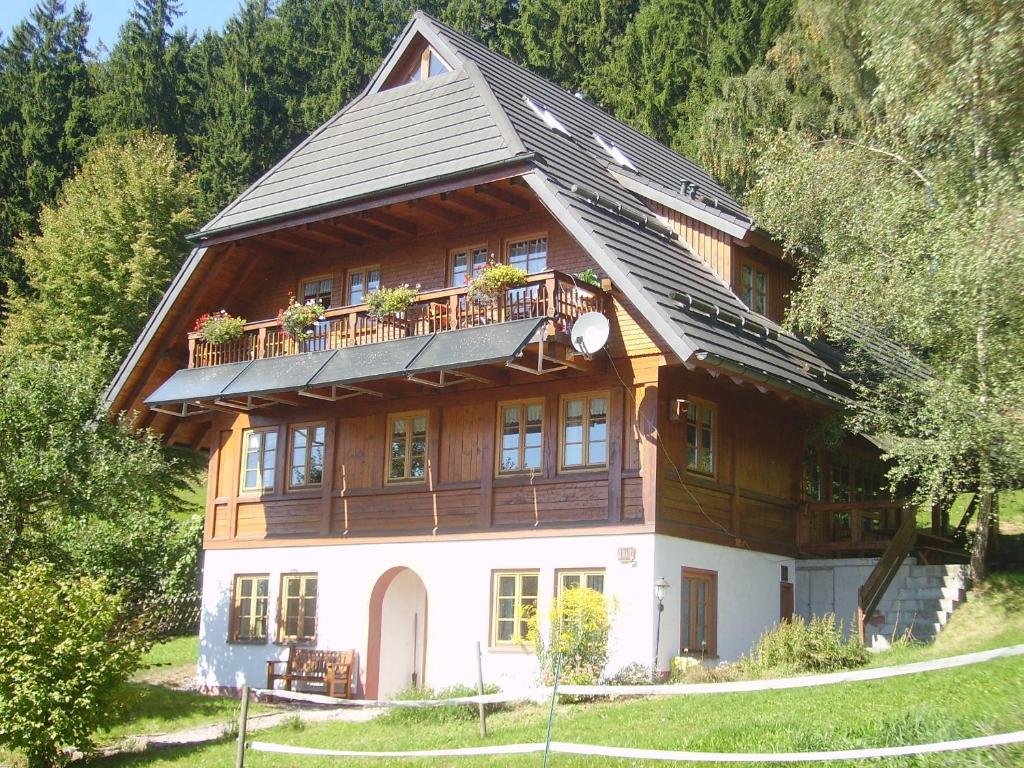 a large wooden house with a balcony at Am Neuhausbauernhof in Königsfeld im Schwarzwald