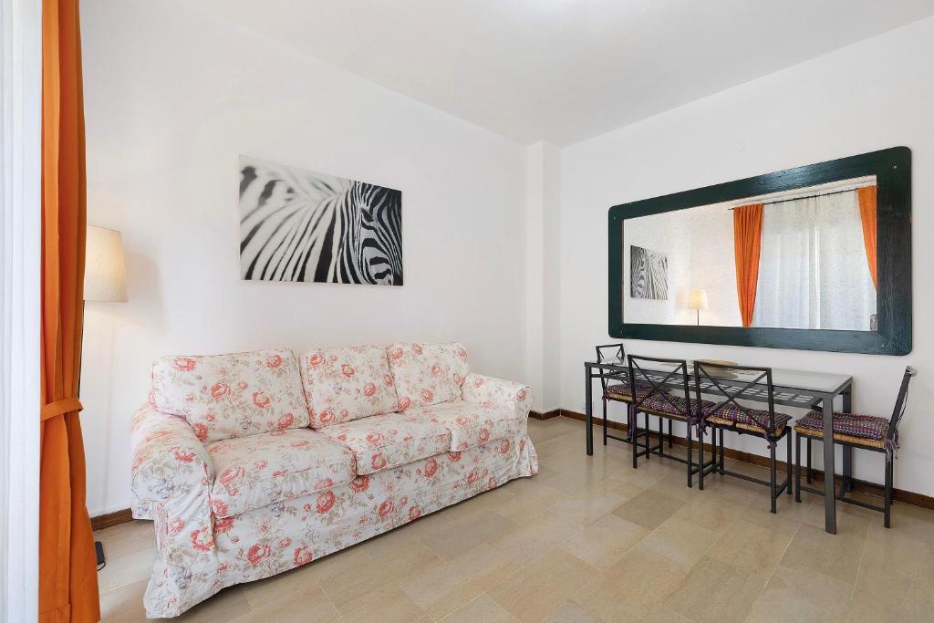 a living room with a couch and a table at Marina in Finale Ligure