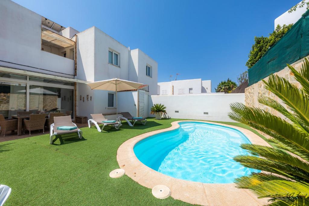 a swimming pool in the backyard of a house at Nikydan in Cala d´Or