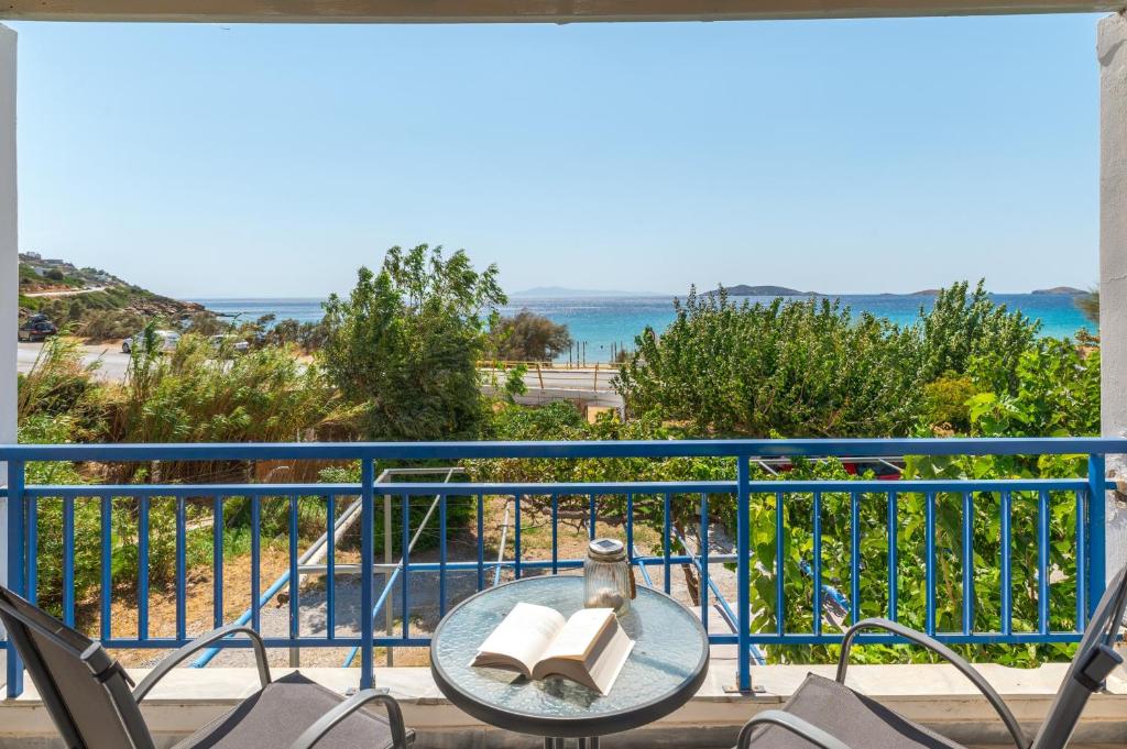 a balcony with a table and chairs and the ocean at Perasma Studio 1b in Kipri