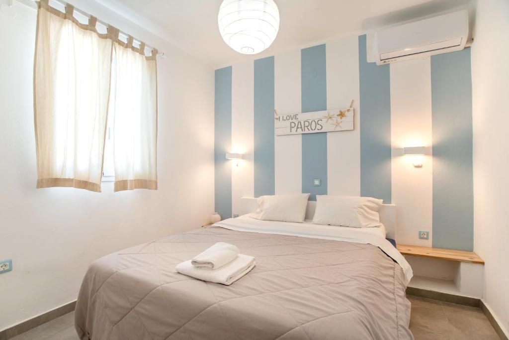 a bedroom with a large bed with two towels on it at Livadia Seaside Studios 1 in Parikia