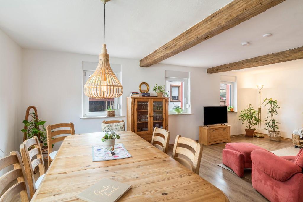 a living room with a wooden table and chairs at Pfälzerwald Idyll in Schwanheim