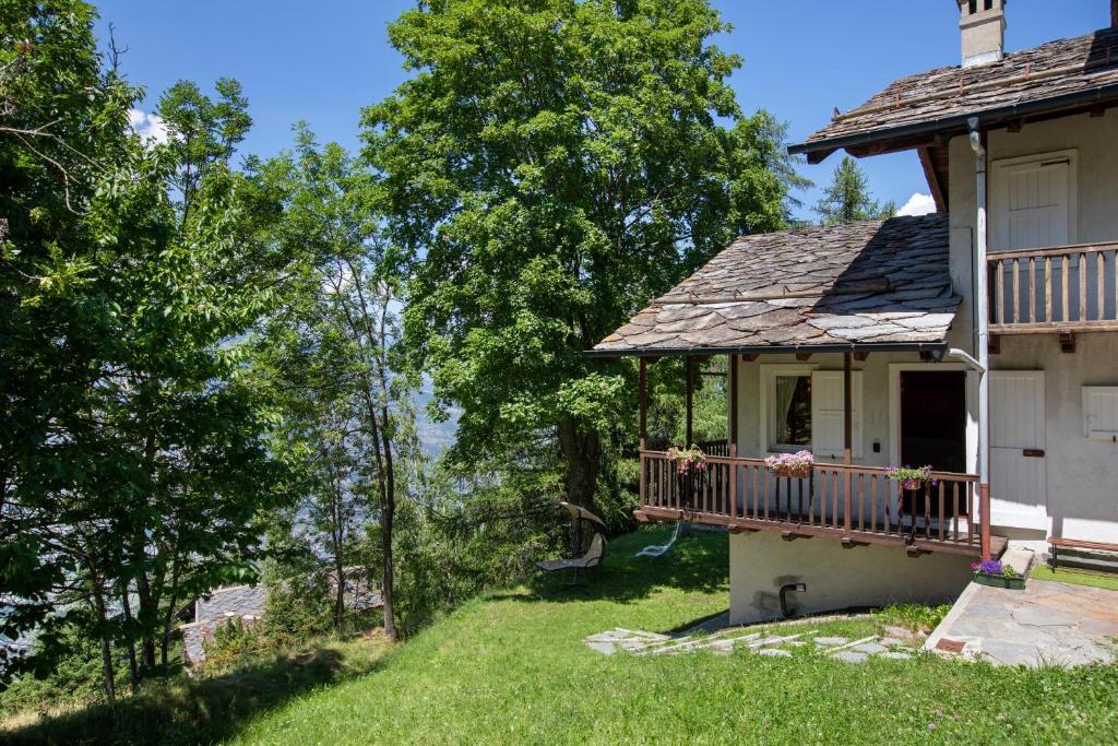 a house with a balcony on a yard at Appartamenti Petite Cerise in Pila