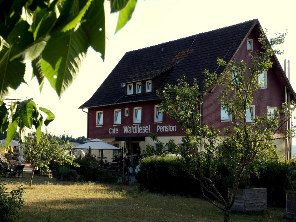 a building with a sign that reads grotewasted person at Pension Waldliesel in Dornstetten