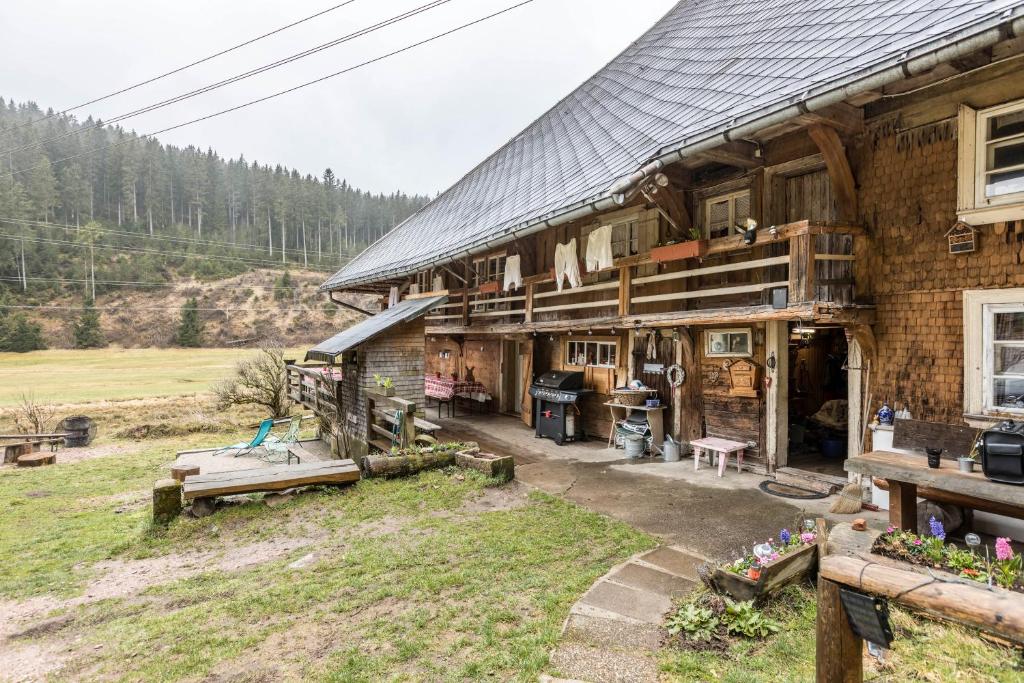 a log cabin with a kitchen in front of it at Schwörerhof in Eisenbach