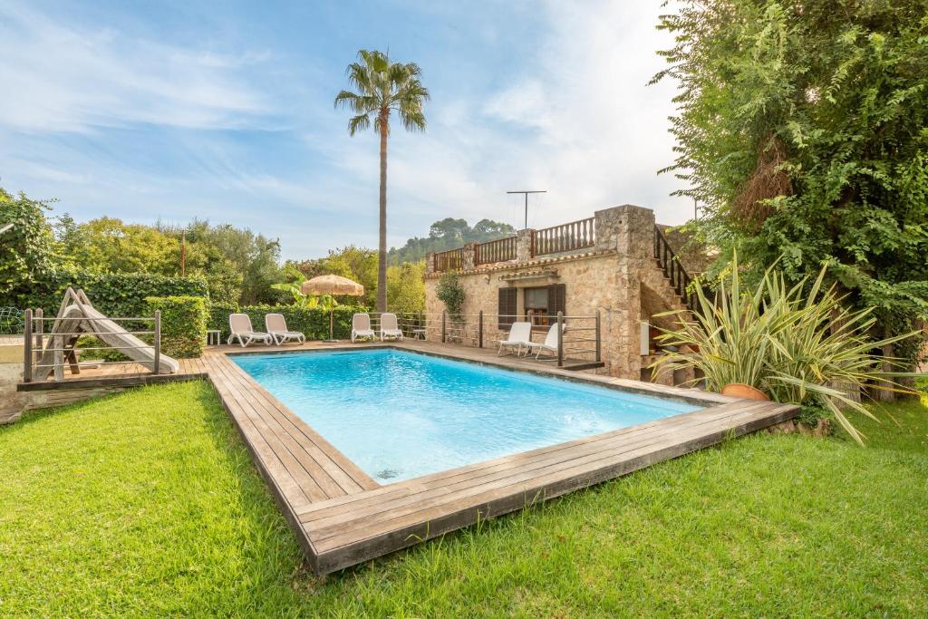 a swimming pool in the yard of a house at Villa Can Sol in Pollença