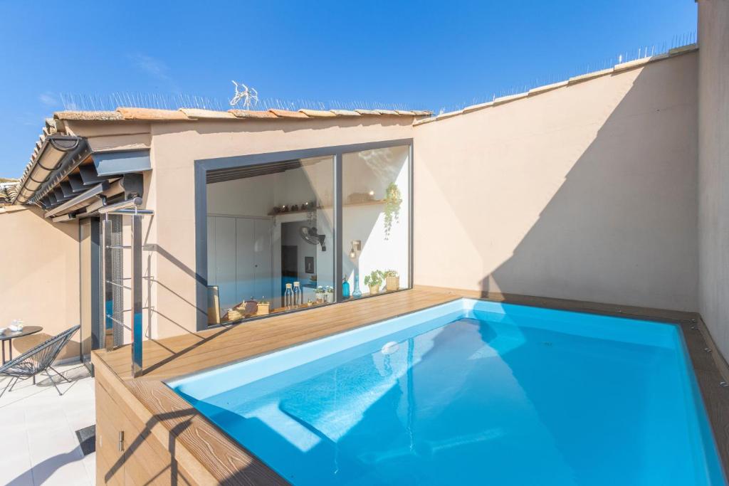 a swimming pool on the side of a house at Cal Comorera in Masoteras