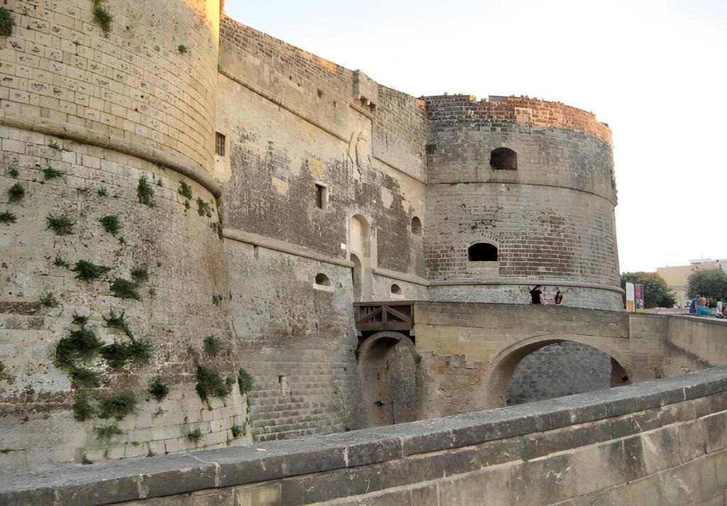 a large castle with a wall and a bridge at Vista Castello - Otranto in Otranto