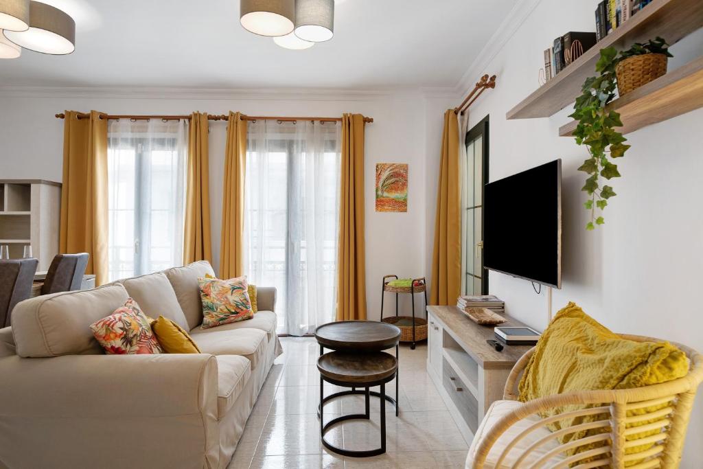 a living room with a couch and a tv at Alpispa in Arrecife