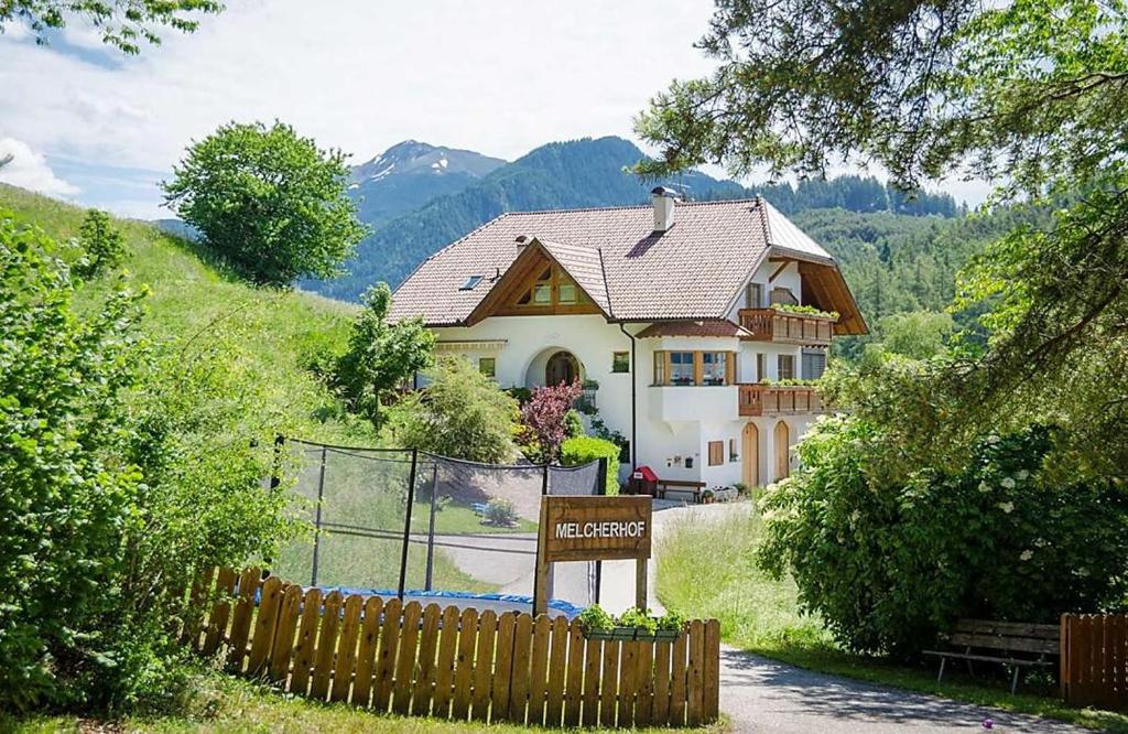 a house with a sign in front of it at Melcherhof in Trodena