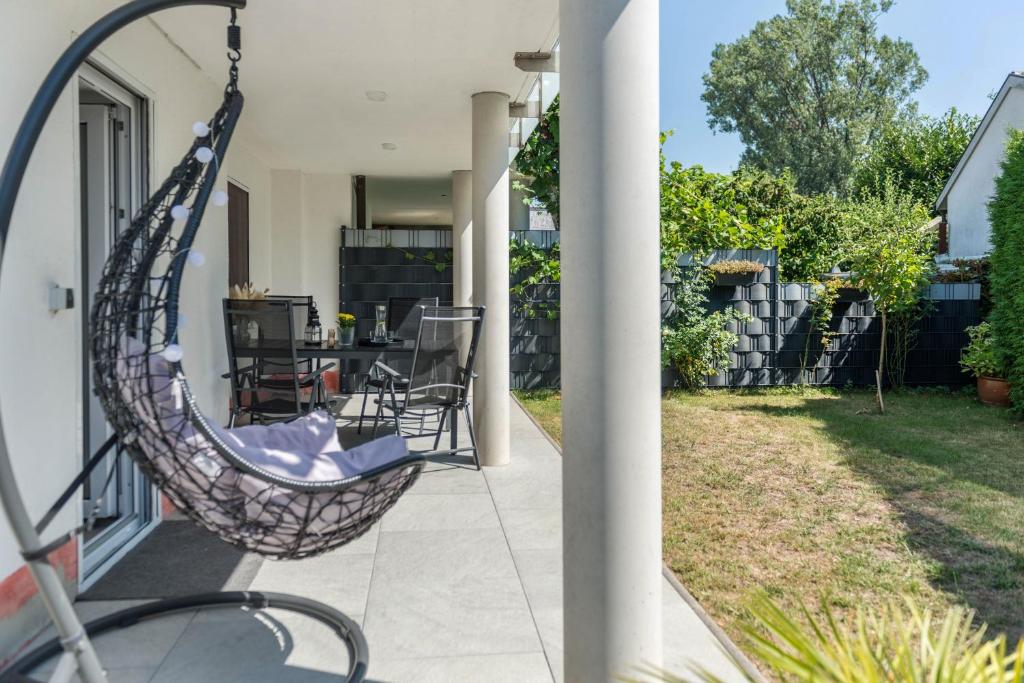 a swing on the porch of a house at Fewo Köse in Uhldingen-Mühlhofen