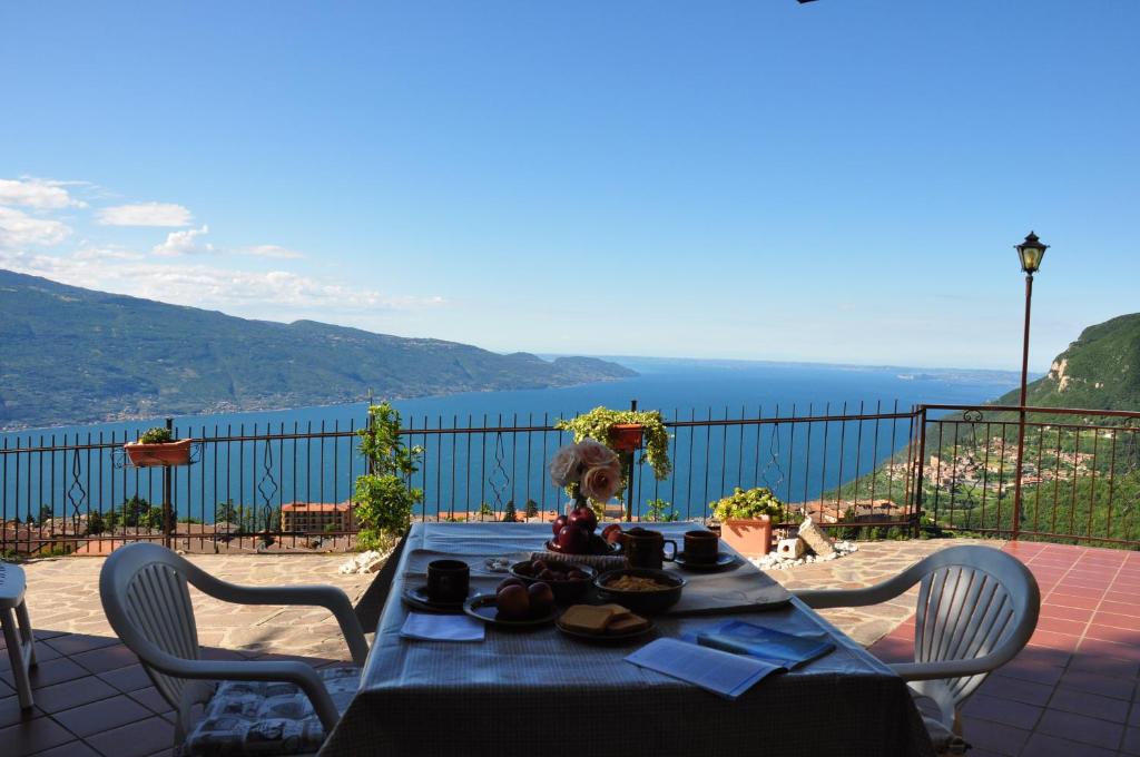 a table with food on top of a balcony at Stella del Garda 2 con terrazza in Tignale
