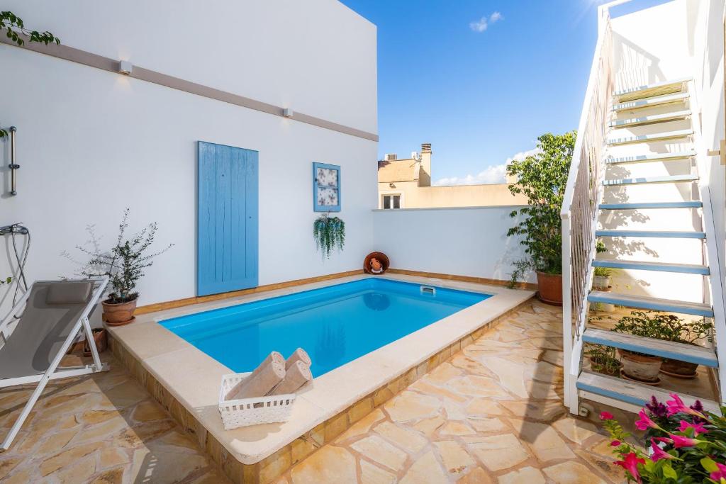 a swimming pool in the backyard of a house at Casa Cantino in Santa Margalida
