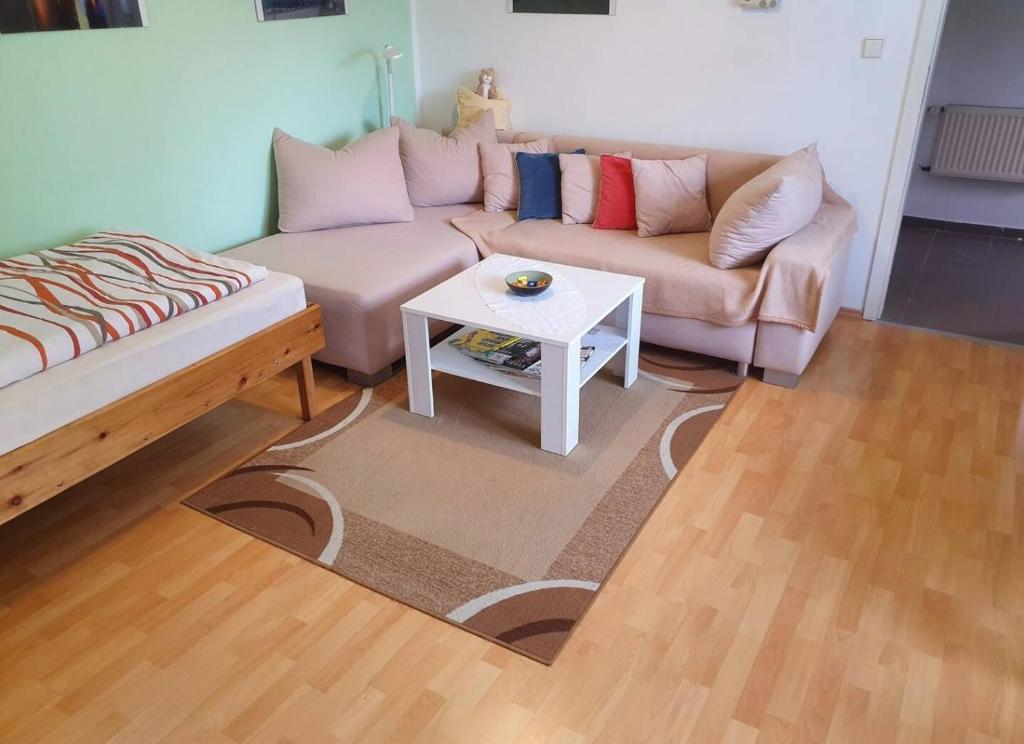 a living room with a couch and a table at Haus im Grünen in Hoppegarten