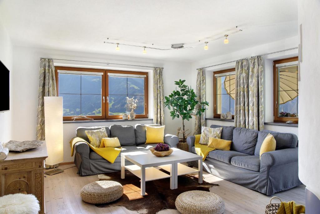 a living room with a couch and a table at Zillertalblick in Zellberg