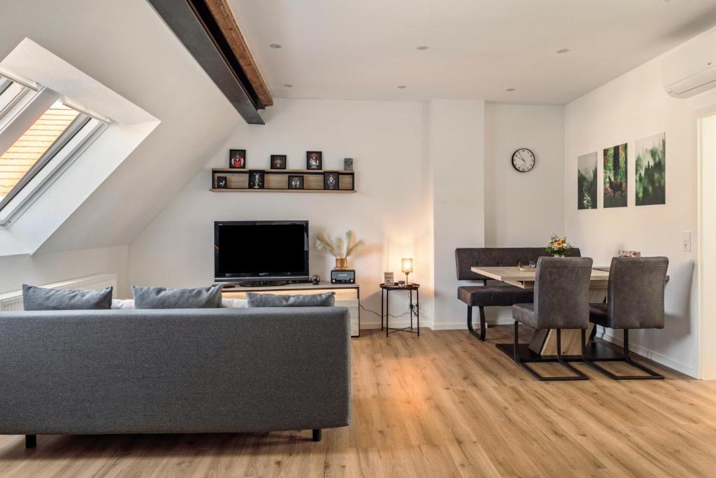 a living room with a couch and a table at Fewo Schmidt in Bahlingen