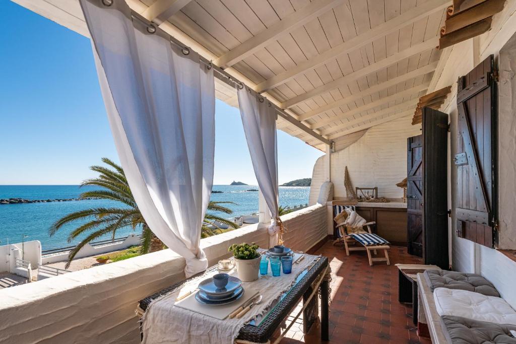 a room with a table and a view of the ocean at Casa Nicoleup in Porto Columbu - Perdʼe Sali