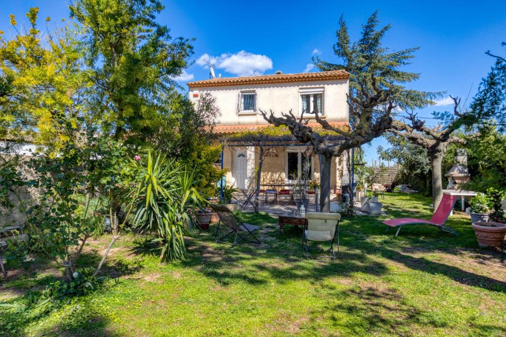 a house with a garden in front of it at Aux Amelierets in Saint-Just