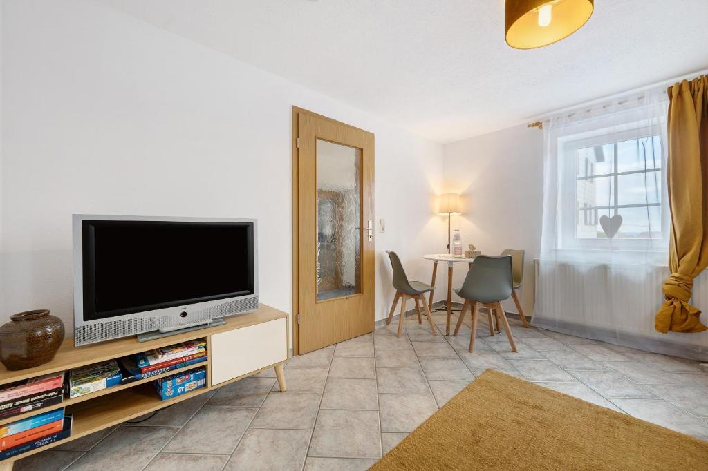 a living room with a flat screen tv on a stand at Ferienwohnung Malia in Neubulach
