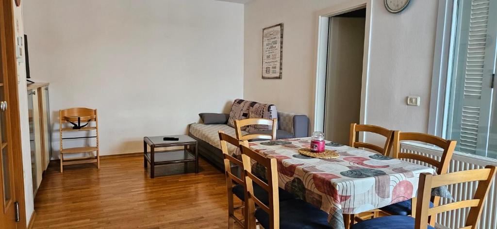 a living room with a table and a couch at Apartment Laguna 70 in Izola