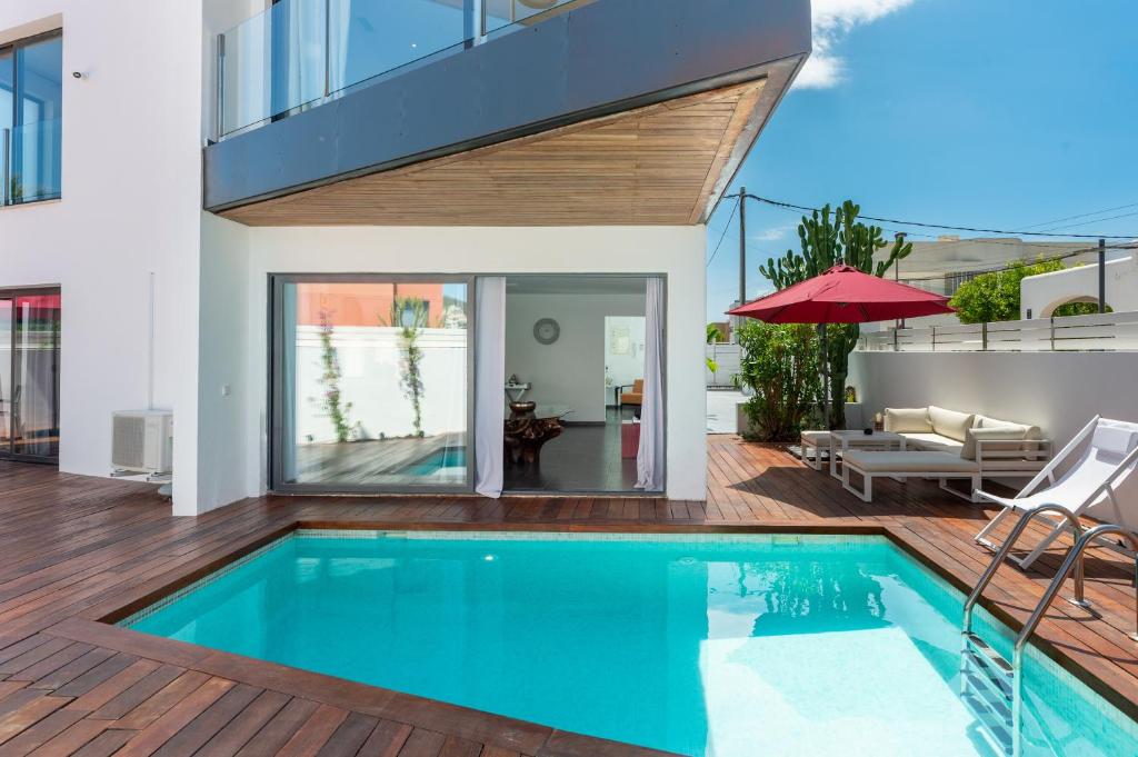 a swimming pool in the middle of a house at Can Olivera in Nuestra Señora de Jesus