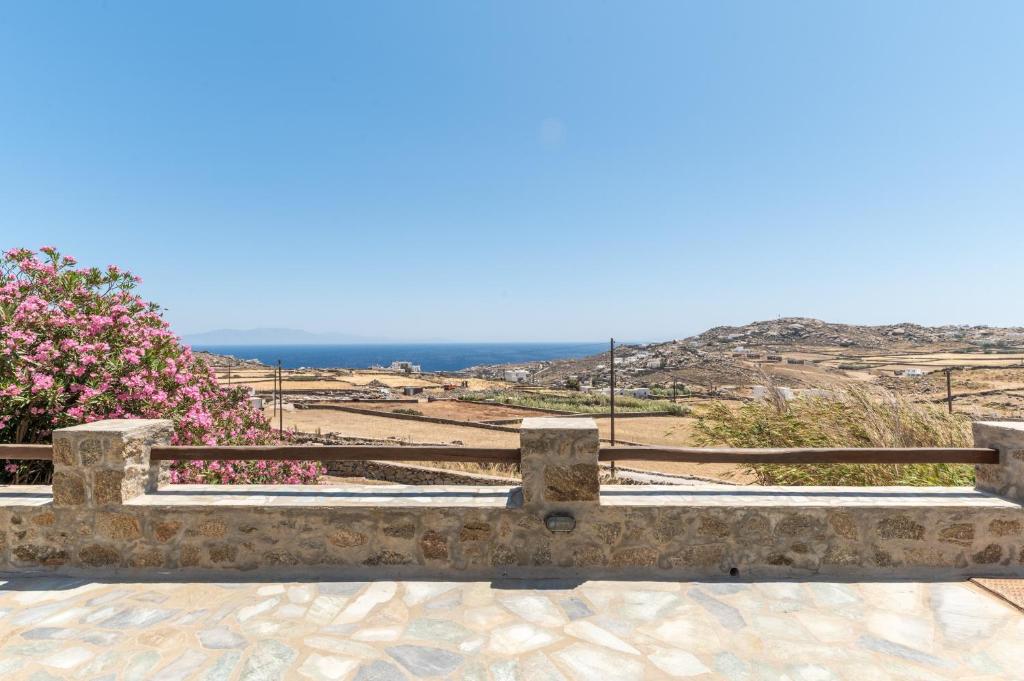 a stone bench with a view of the ocean at Anastasias Studios Mykonos in Plintri