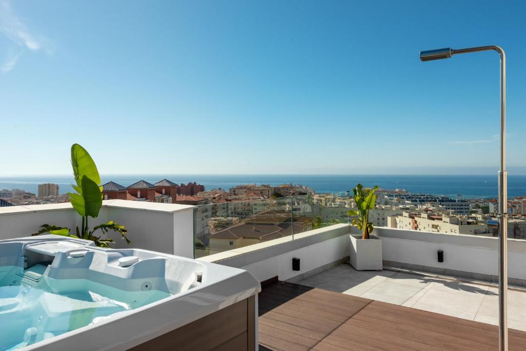a bathroom with a bath tub on a balcony at Penthouse Apt With Ocean View in Estepona