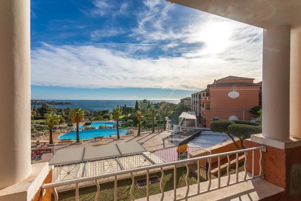 a view from the balcony of a resort with a swimming pool at Appartement Cap Esterel St Raphaël in Saint-Raphaël