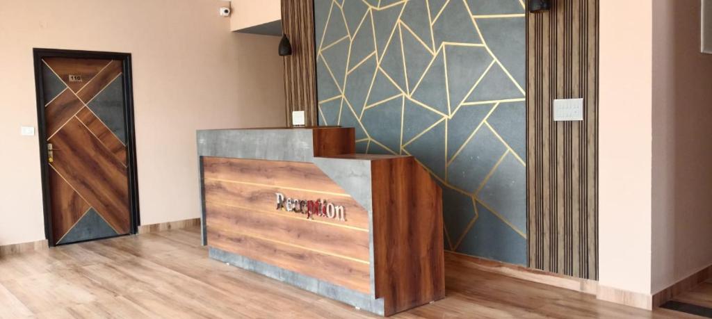 a hallway with a wooden door and a wall with a wall at Elixir Boarding & Lodging in Bangalore