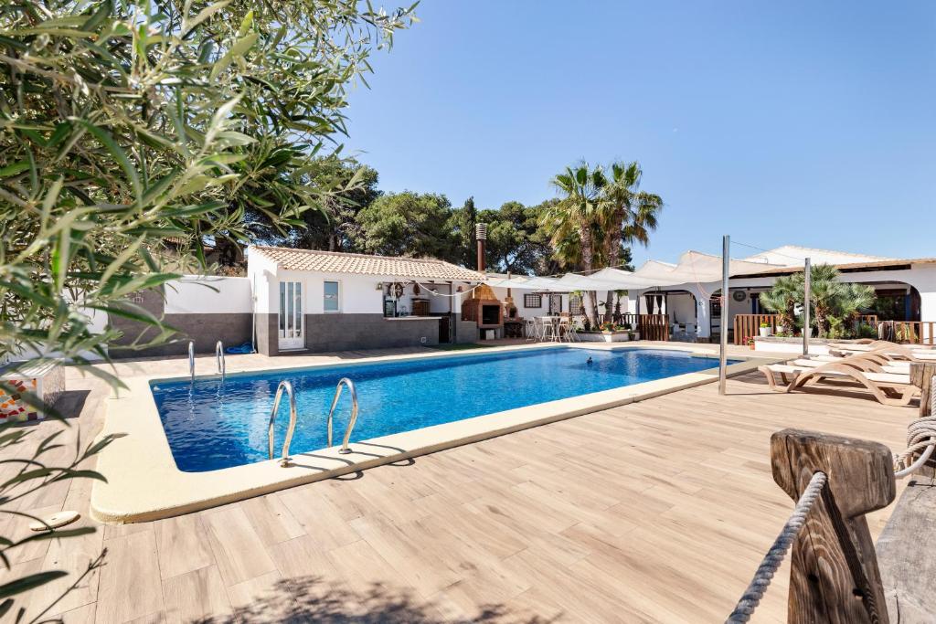 a swimming pool in front of a house at Ecoturismo Calblanque in Las Barracas